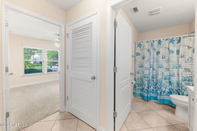 305 Green Turtle Ln, Saint Augustine, FL 32086 - full bath featuring tile patterned flooring, ceiling fan, toilet, a shower with shower curtain, and baseboards