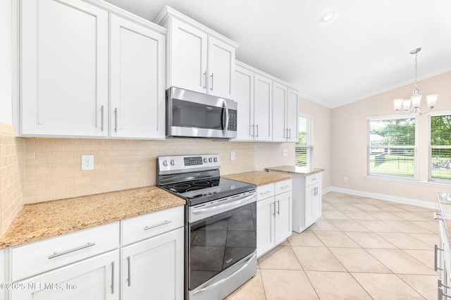 305 Green Turtle Ln, Saint Augustine, FL 32086 - kitchen featuring appliances with stainless steel finishes, lofted ceiling, decorative backsplash, crown molding, and a chandelier