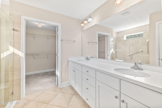305 Green Turtle Ln, Saint Augustine, FL 32086 - bathroom featuring double vanity, a spacious closet, a stall shower, tile patterned flooring, and baseboards