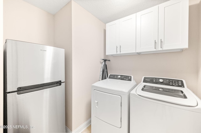 305 Green Turtle Ln, Saint Augustine, FL 32086 - washroom featuring cabinet space, washer and dryer, baseboards, and a textured ceiling