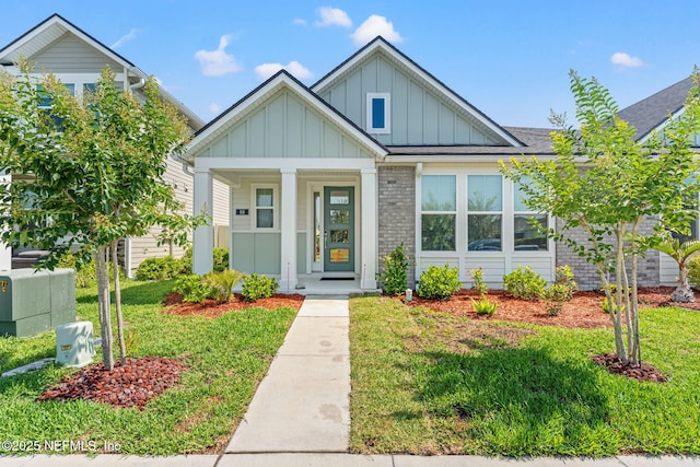 68 Cabana Dr, Ponte Vedra, FL 32081 - view of front facade with board and batten siding, a front lawn, and a porch