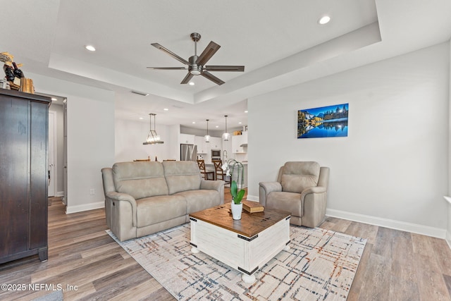 68 Cabana Dr, Ponte Vedra, FL 32081 - living area featuring a raised ceiling, ceiling fan, baseboards, light wood-style flooring, and recessed lighting