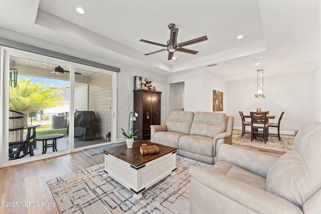 68 Cabana Dr, Ponte Vedra, FL 32081 - living room with a ceiling fan, a raised ceiling, light wood-style floors, recessed lighting, and baseboards