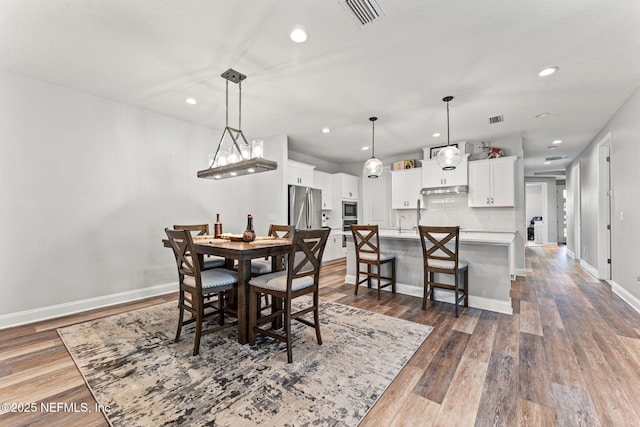 68 Cabana Dr, Ponte Vedra, FL 32081 - dining room with dark wood-style flooring, recessed lighting, and baseboards