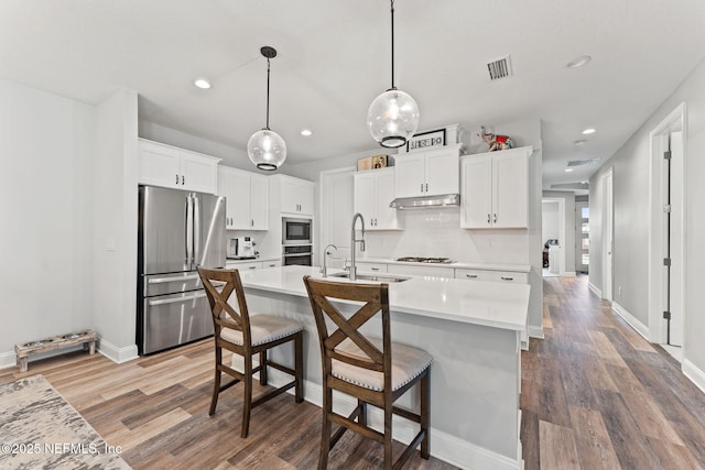 68 Cabana Dr, Ponte Vedra, FL 32081 - kitchen with appliances with stainless steel finishes, a sink, wood finished floors, light countertops, and recessed lighting