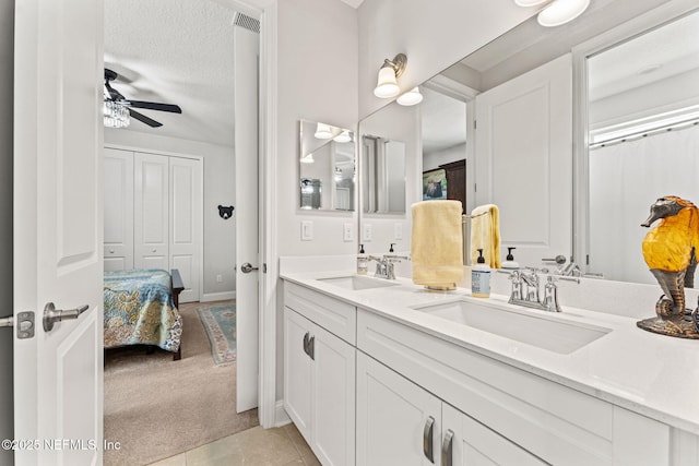 68 Cabana Dr, Ponte Vedra, FL 32081 - ensuite bathroom with ceiling fan, double vanity, tile patterned flooring, and a textured ceiling