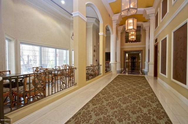 400 E Bay St Unit 1010, Jacksonville, FL 32202 - hall featuring ornate columns, a chandelier, crown molding, and a towering ceiling