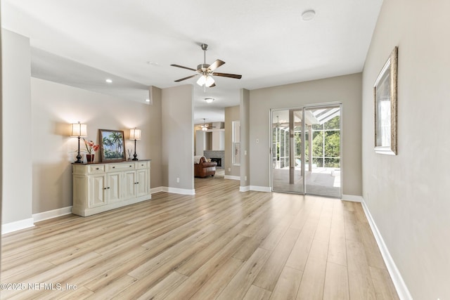 3820 Danforth Dr W, Jacksonville, FL 32224 - unfurnished living room featuring ceiling fan, light wood-style flooring, and baseboards