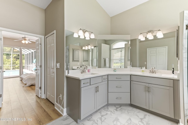 3820 Danforth Dr W, Jacksonville, FL 32224 - ensuite bathroom with a ceiling fan, double vanity, healthy amount of natural light, high vaulted ceiling, and marble finish flooring