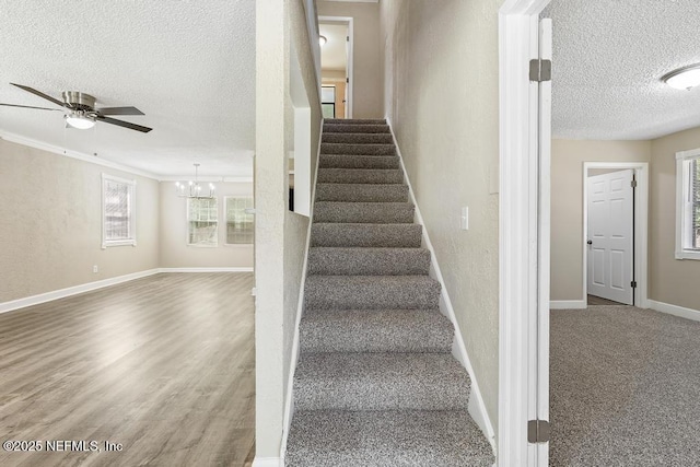 2718 Parkrus Ln, Jacksonville, FL 32208 - staircase with a textured ceiling, baseboards, a chandelier, a ceiling fan, and wood finished floors