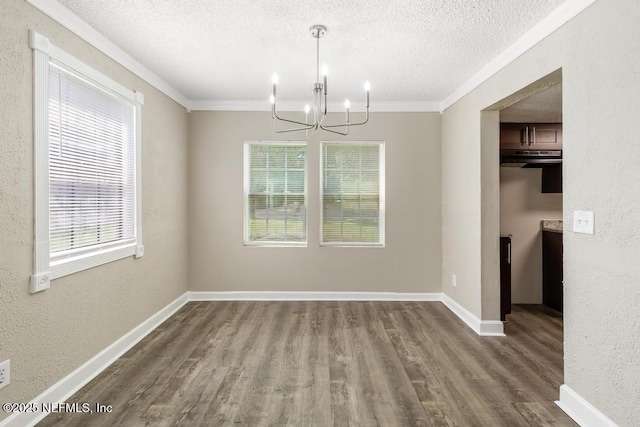 2718 Parkrus Ln, Jacksonville, FL 32208 - unfurnished dining area featuring a chandelier, a textured ceiling, healthy amount of natural light, ornamental molding, and wood finished floors