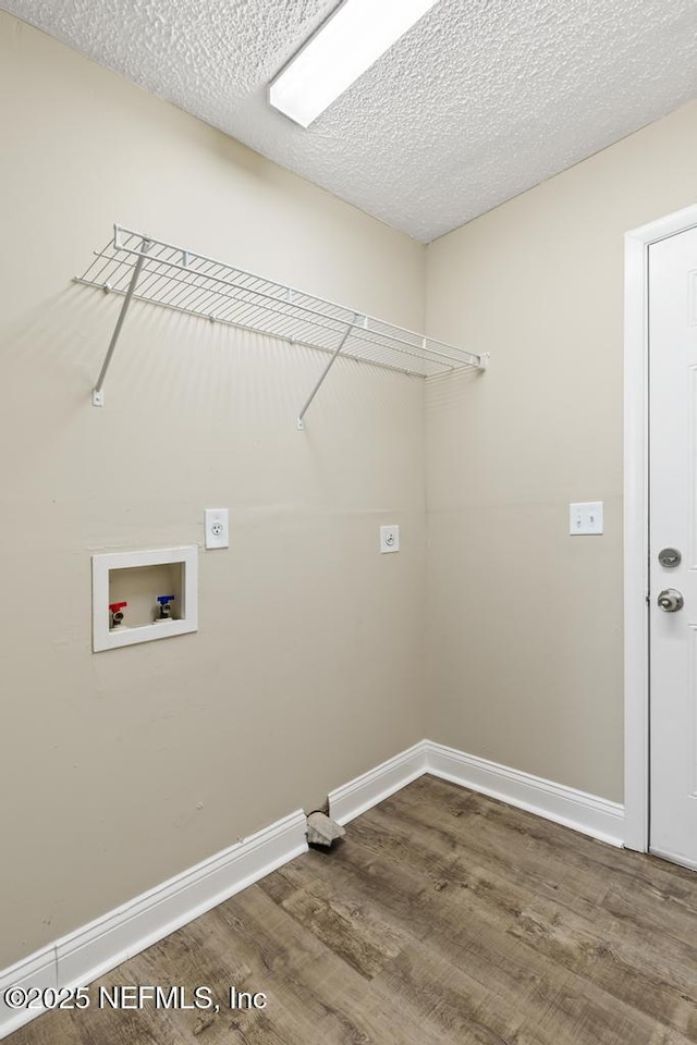 2718 Parkrus Ln, Jacksonville, FL 32208 - laundry room with hookup for a washing machine, wood finished floors, baseboards, electric dryer hookup, and a textured ceiling