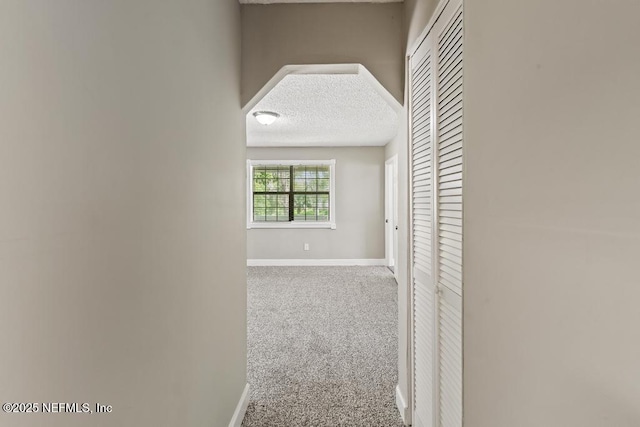 2718 Parkrus Ln, Jacksonville, FL 32208 - hallway featuring baseboards, a textured ceiling, and carpet floors