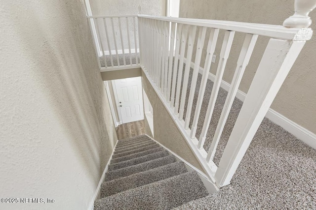 2718 Parkrus Ln, Jacksonville, FL 32208 - stairs with a textured wall and baseboards