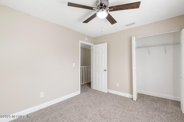 2718 Parkrus Ln, Jacksonville, FL 32208 - unfurnished bedroom featuring carpet floors, a closet, baseboards, and a ceiling fan
