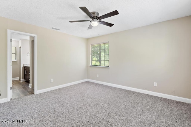 2718 Parkrus Ln, Jacksonville, FL 32208 - empty room with carpet flooring, baseboards, ceiling fan, and a textured ceiling