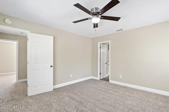 2718 Parkrus Ln, Jacksonville, FL 32208 - unfurnished bedroom featuring carpet floors, baseboards, a textured ceiling, and ceiling fan