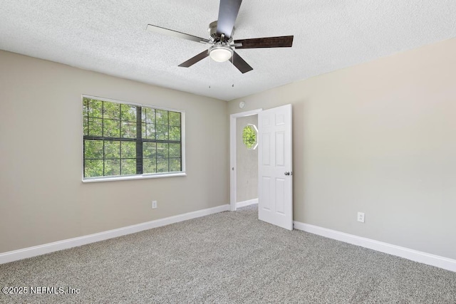 2718 Parkrus Ln, Jacksonville, FL 32208 - unfurnished bedroom with a textured ceiling, carpet, baseboards, and a ceiling fan