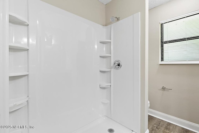 2718 Parkrus Ln, Jacksonville, FL 32208 - full bath with baseboards, a stall shower, wood finished floors, and toilet