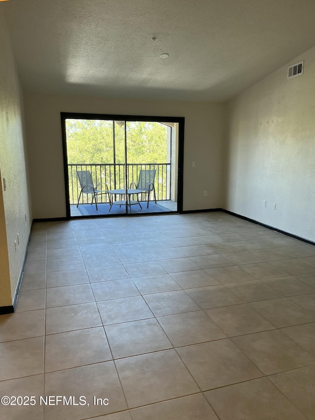 425 Timberwalk Ct Unit 1135, Ponte Vedra Beach, FL 32082 - unfurnished room featuring a textured ceiling, baseboards, and tile patterned flooring