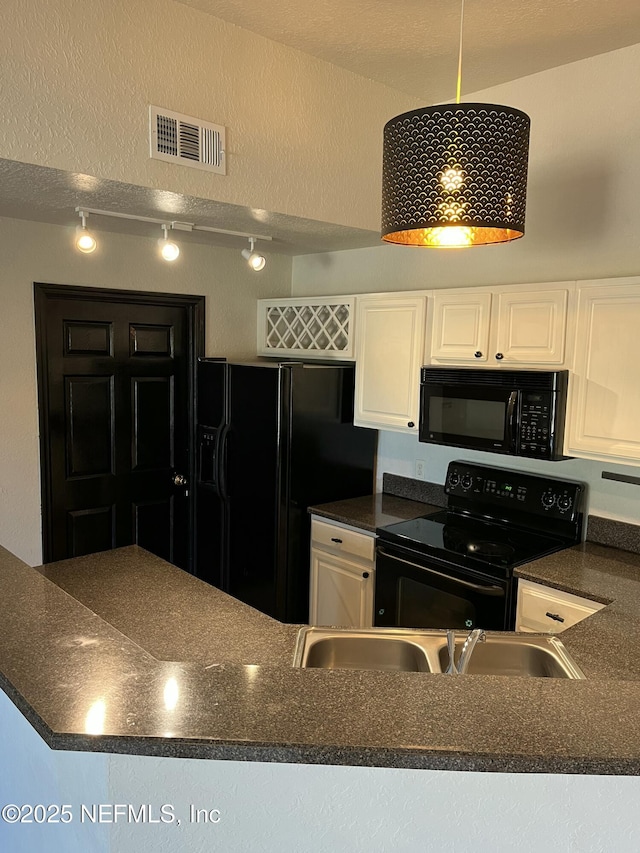 425 Timberwalk Ct Unit 1135, Ponte Vedra Beach, FL 32082 - kitchen with black appliances, dark countertops, white cabinets, rail lighting, and a sink