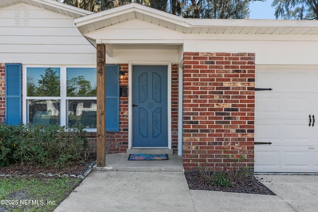 364 Aries Dr, Orange Park, FL 32073 - property entrance featuring an attached garage and brick siding