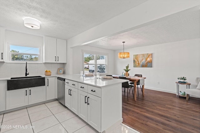 364 Aries Dr, Orange Park, FL 32073 - kitchen with a sink, a peninsula, dishwasher, backsplash, and light countertops