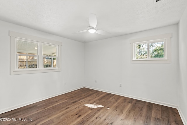 364 Aries Dr, Orange Park, FL 32073 - empty room featuring dark wood-style floors, baseboards, a ceiling fan, and a textured ceiling