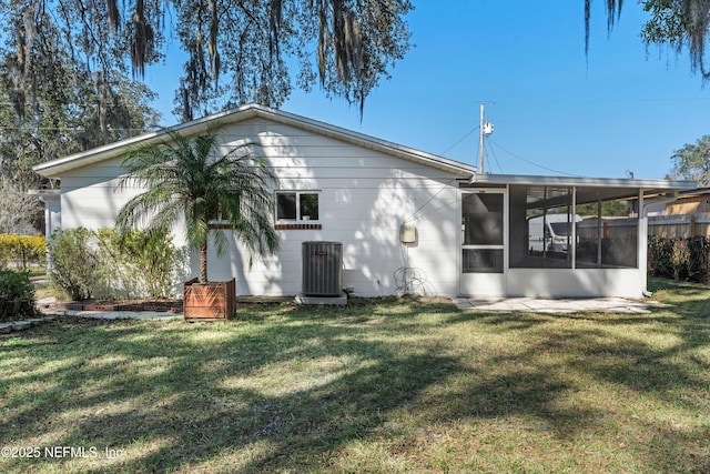 364 Aries Dr, Orange Park, FL 32073 - rear view of house with a sunroom, a yard, and central AC unit
