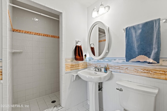 2327 Costa Verde Blvd Unit 201, Jacksonville Beach, FL 32250 - full bath featuring toilet, a wainscoted wall, and a stall shower