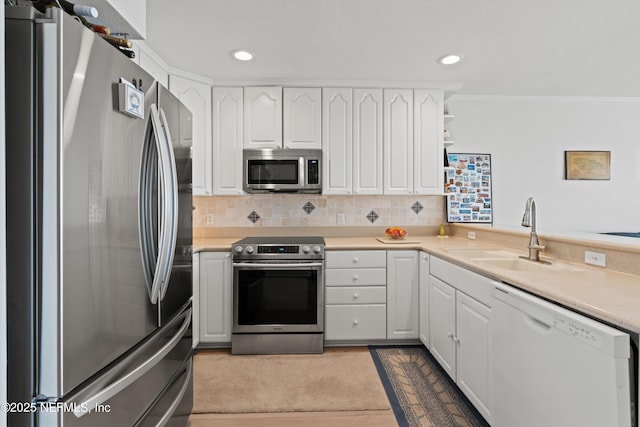 2327 Costa Verde Blvd Unit 201, Jacksonville Beach, FL 32250 - kitchen with stainless steel appliances, a sink, white cabinetry, crown molding, and recessed lighting