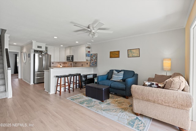 2327 Costa Verde Blvd Unit 201, Jacksonville Beach, FL 32250 - living area featuring ceiling fan, recessed lighting, light wood finished floors, ornamental molding, and stairs