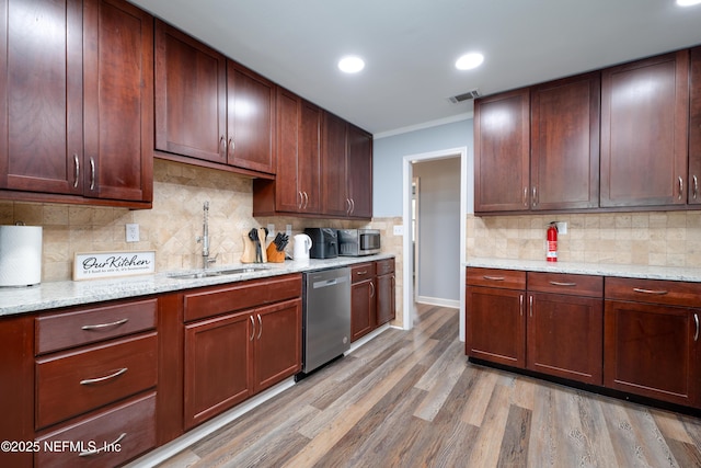 5253 Royce Ave, Jacksonville, FL 32205 - kitchen featuring appliances with stainless steel finishes, a sink, light wood-style floors, recessed lighting, and decorative backsplash