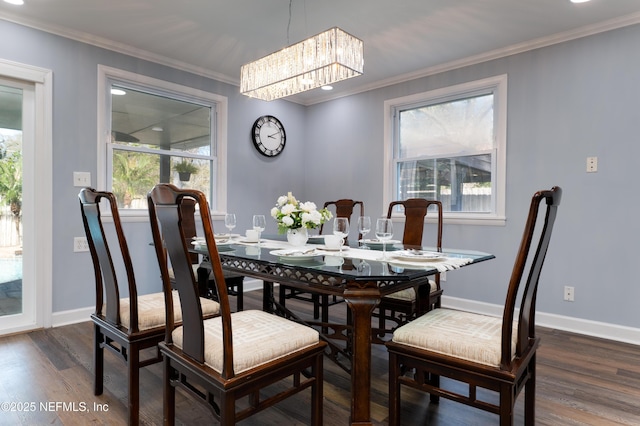 5253 Royce Ave, Jacksonville, FL 32205 - dining area featuring a chandelier, crown molding, dark wood finished floors, and baseboards