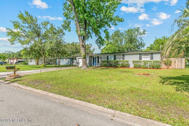 1702 Dibble Cir E, Jacksonville, FL 32246 - view of front of house with driveway, a garage, and a front lawn