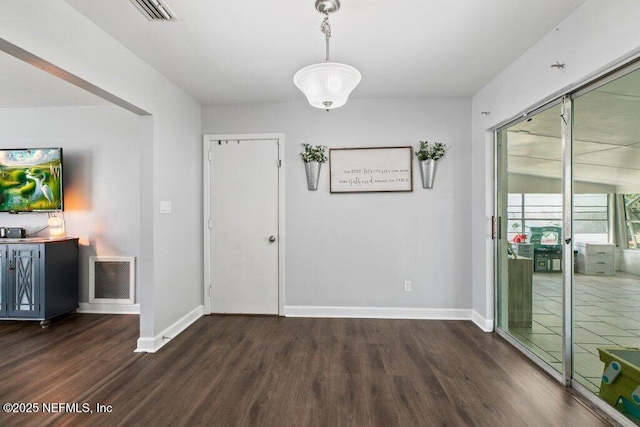 1702 Dibble Cir E, Jacksonville, FL 32246 - unfurnished dining area with dark wood-type flooring and baseboards