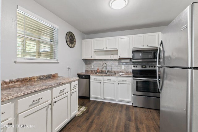 1702 Dibble Cir E, Jacksonville, FL 32246 - kitchen featuring stainless steel appliances, a sink, white cabinetry, open shelves, and tasteful backsplash