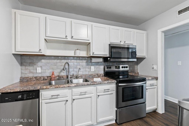 1702 Dibble Cir E, Jacksonville, FL 32246 - kitchen with stainless steel appliances, a sink, white cabinets, and open shelves
