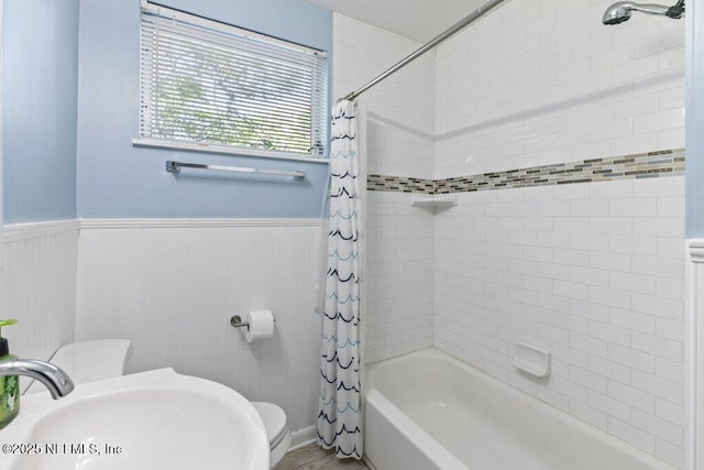 1702 Dibble Cir E, Jacksonville, FL 32246 - bathroom with a sink, shower / bath combination with curtain, wainscoting, and toilet