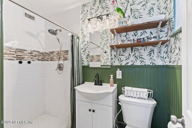 1702 Dibble Cir E, Jacksonville, FL 32246 - full bath featuring wallpapered walls, a stall shower, a wainscoted wall, toilet, and vanity