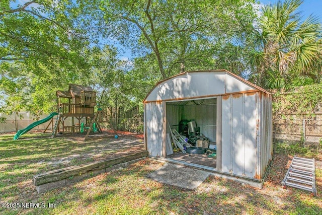 1702 Dibble Cir E, Jacksonville, FL 32246 - view of shed featuring a fenced backyard and a playground