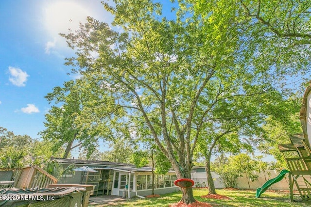 1702 Dibble Cir E, Jacksonville, FL 32246 - view of yard featuring a playground and a sunroom