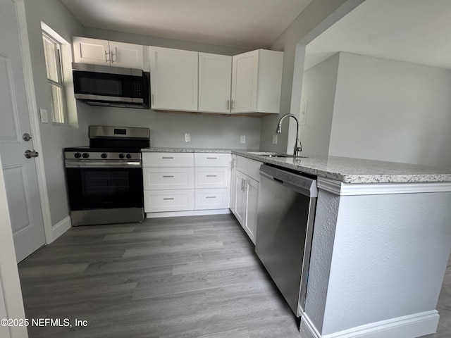 3114 Breve Dr, Jacksonville, FL 32209 - kitchen with appliances with stainless steel finishes, a sink, light stone countertops, and white cabinets
