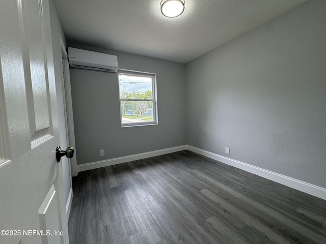 3114 Breve Dr, Jacksonville, FL 32209 - unfurnished bedroom featuring a wall mounted air conditioner, dark wood-style flooring, and baseboards