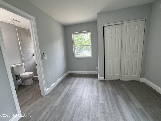 3114 Breve Dr, Jacksonville, FL 32209 - unfurnished bedroom with wood finished floors, baseboards, a closet, and ensuite bathroom