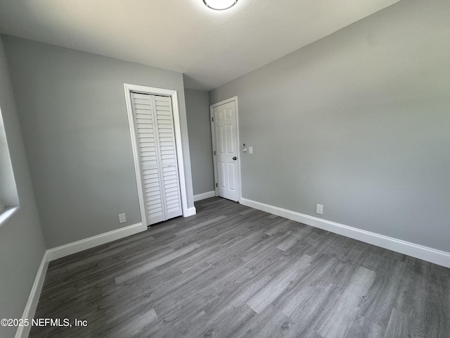 3114 Breve Dr, Jacksonville, FL 32209 - unfurnished bedroom with baseboards, a closet, and dark wood finished floors