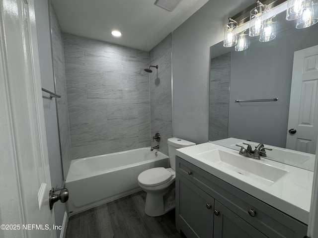 3114 Breve Dr, Jacksonville, FL 32209 - full bath featuring wood finished floors, toilet, vanity, bathtub / shower combination, and recessed lighting