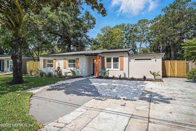 6114 Suwanee Rd, Jacksonville, FL 32217 - view of front of house with stucco siding and driveway