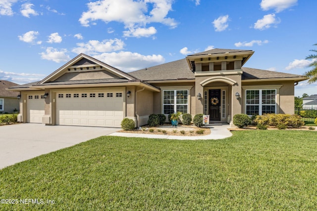 32479 Willow Parke Cir, Fernandina Beach, FL 32034 - view of front of house with stucco siding, concrete driveway, an attached garage, and a shingled roof