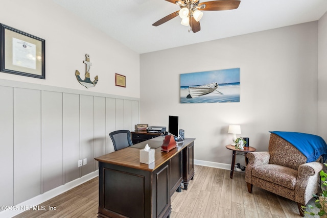 32479 Willow Parke Cir, Fernandina Beach, FL 32034 - home office with light wood-style flooring, a ceiling fan, wainscoting, and baseboards